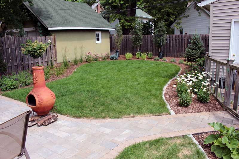 Freshly laid sod in a small Minneapolis backyard after grading and patio construction