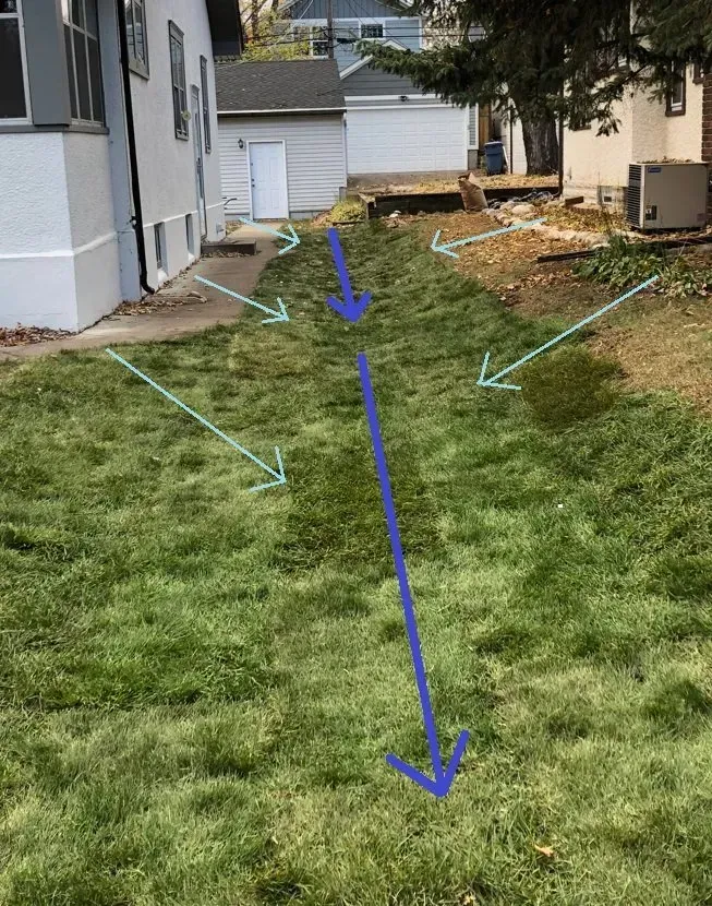 Side yard that sloped toward the house, regraded with a lawn swale to redirect water to the street, St. Paul