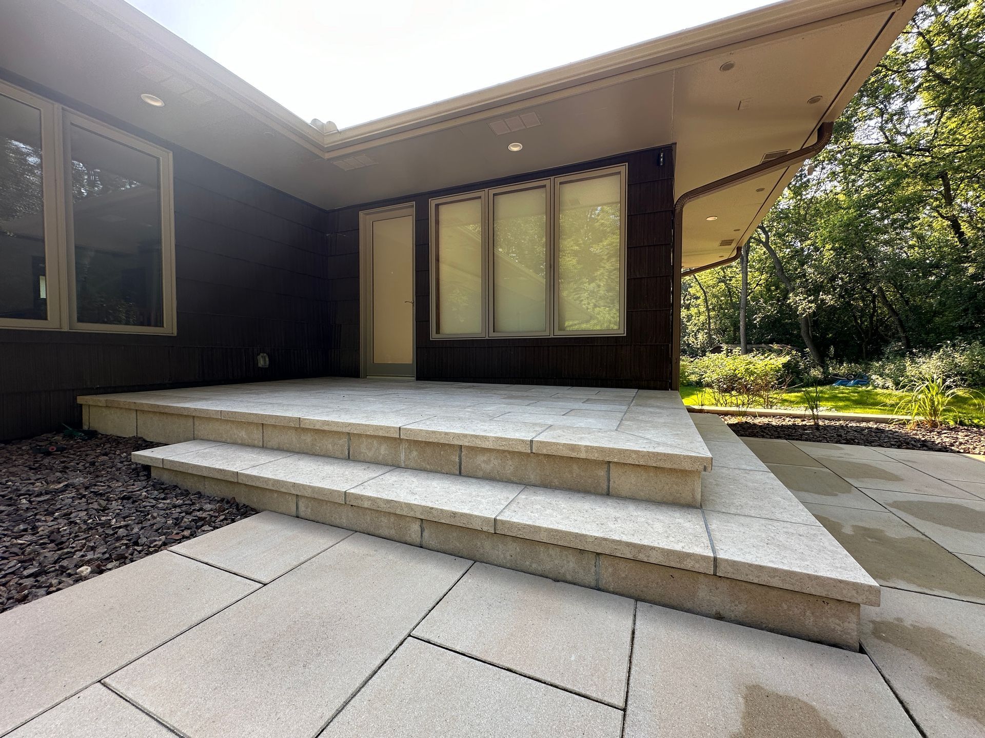 Customer stone back patio door landing and step onto customer stone patio in Hopkins MN