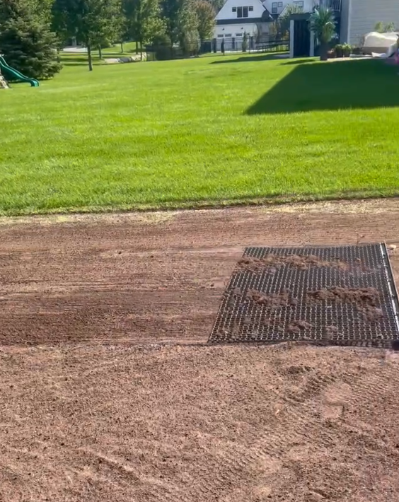 regrading a backyard lawn with grading tool mesh metal lawn drag