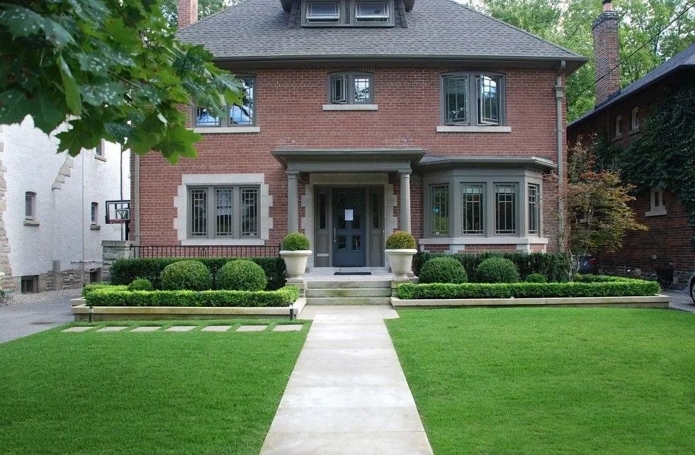 Formal traditional style landscaping with hedges and evergreens clean cut simple but elegant  
