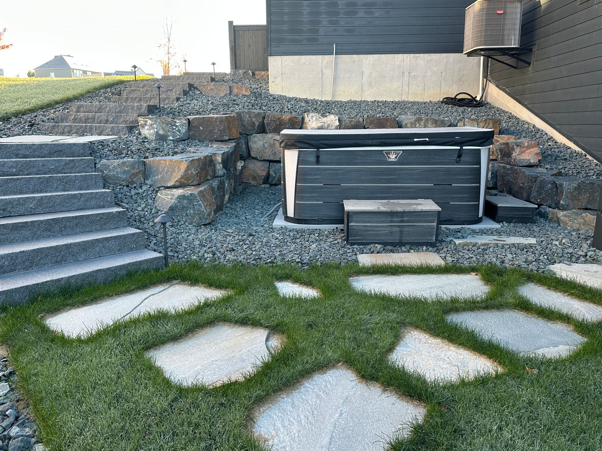 The space for the hot tub cut into the side yard hill, creating new functional yard space.