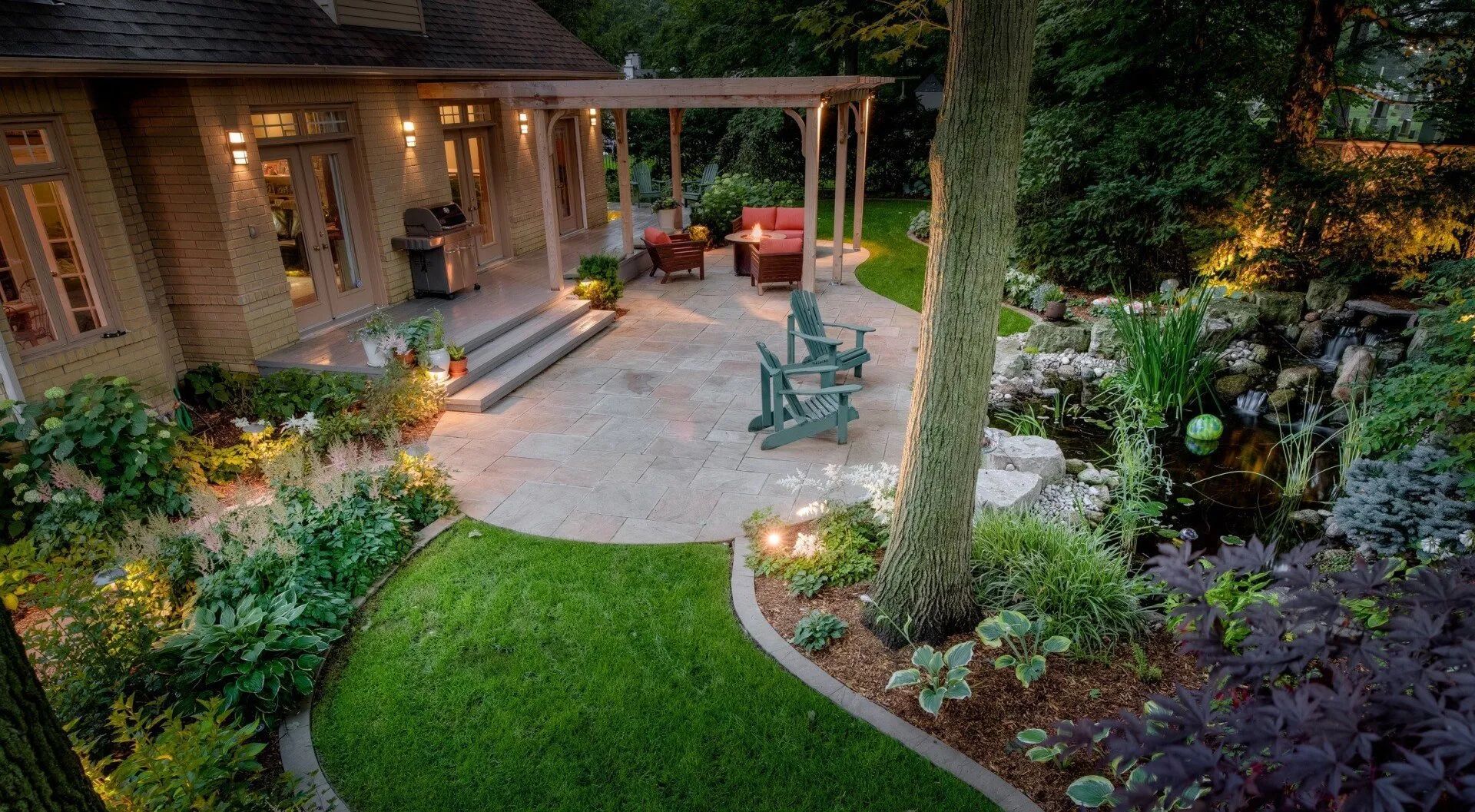 backyard escape with natural stone patio pergola water feature Minnesota 