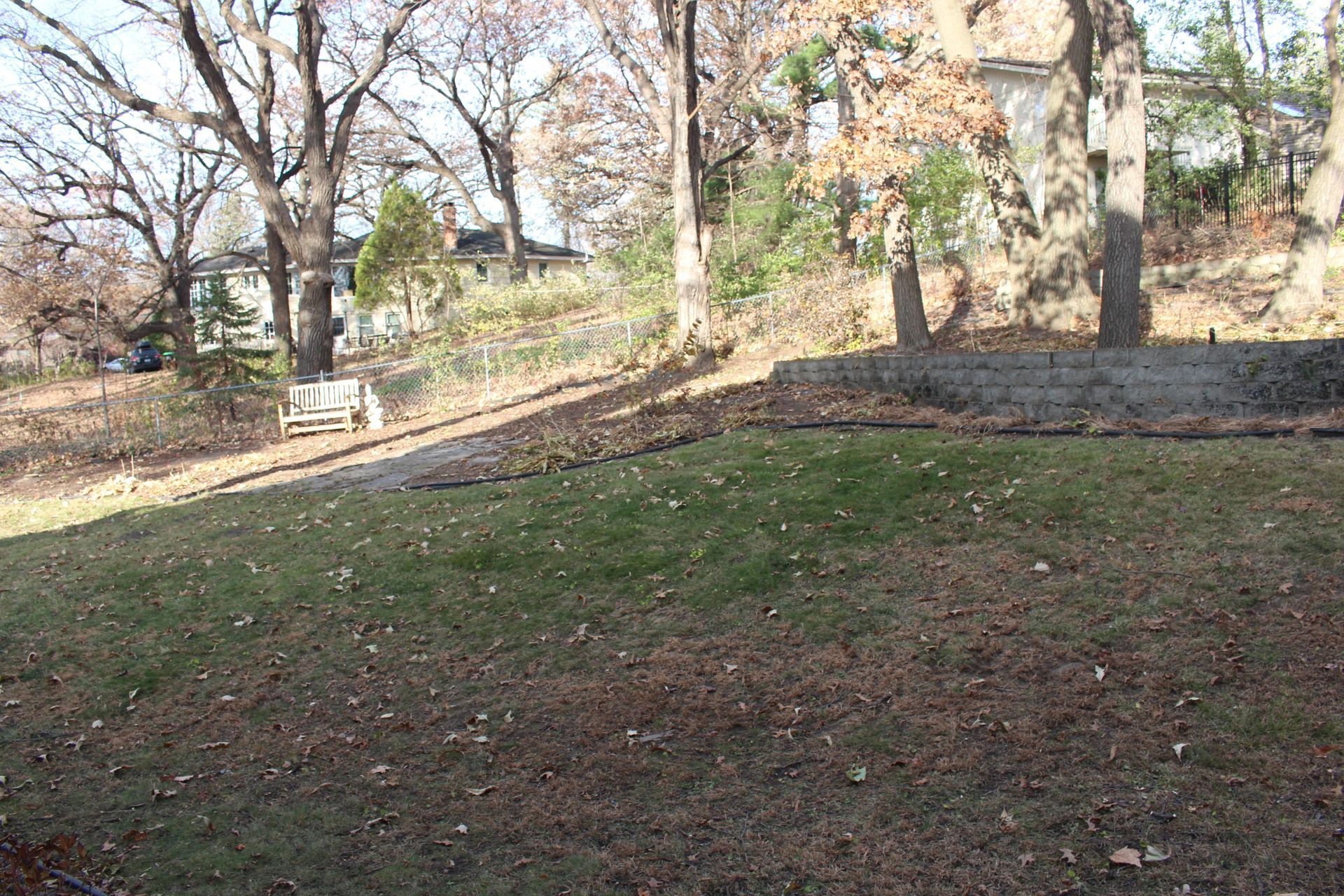Before picture of a backyard on a hill with no flat yard space.