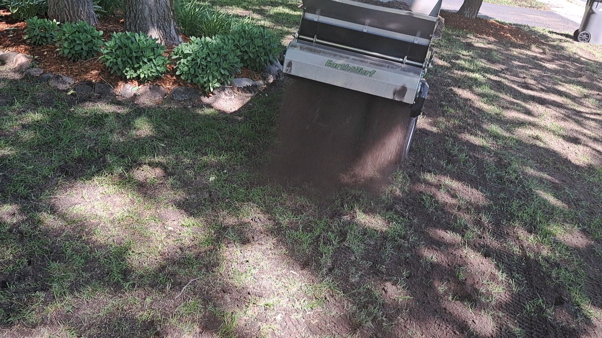 Cart tipping organic topsoil. 