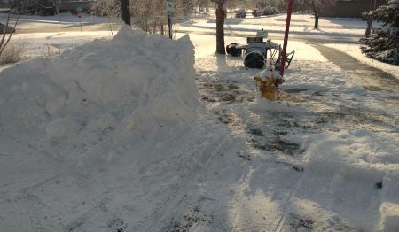 Clearing snow around fire hydrants for fire safety in Minnesota