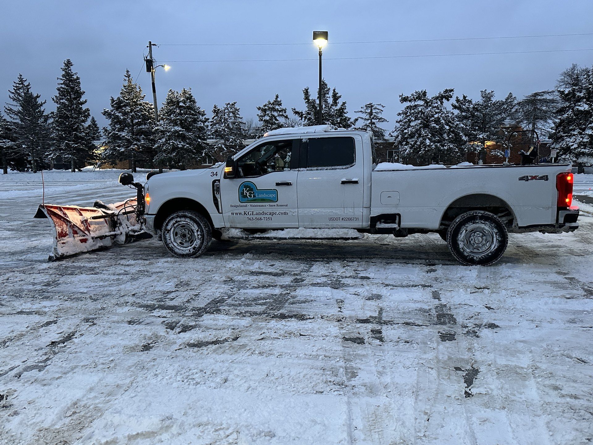 KG Landscape plow truck parked in a cleared commercial lot