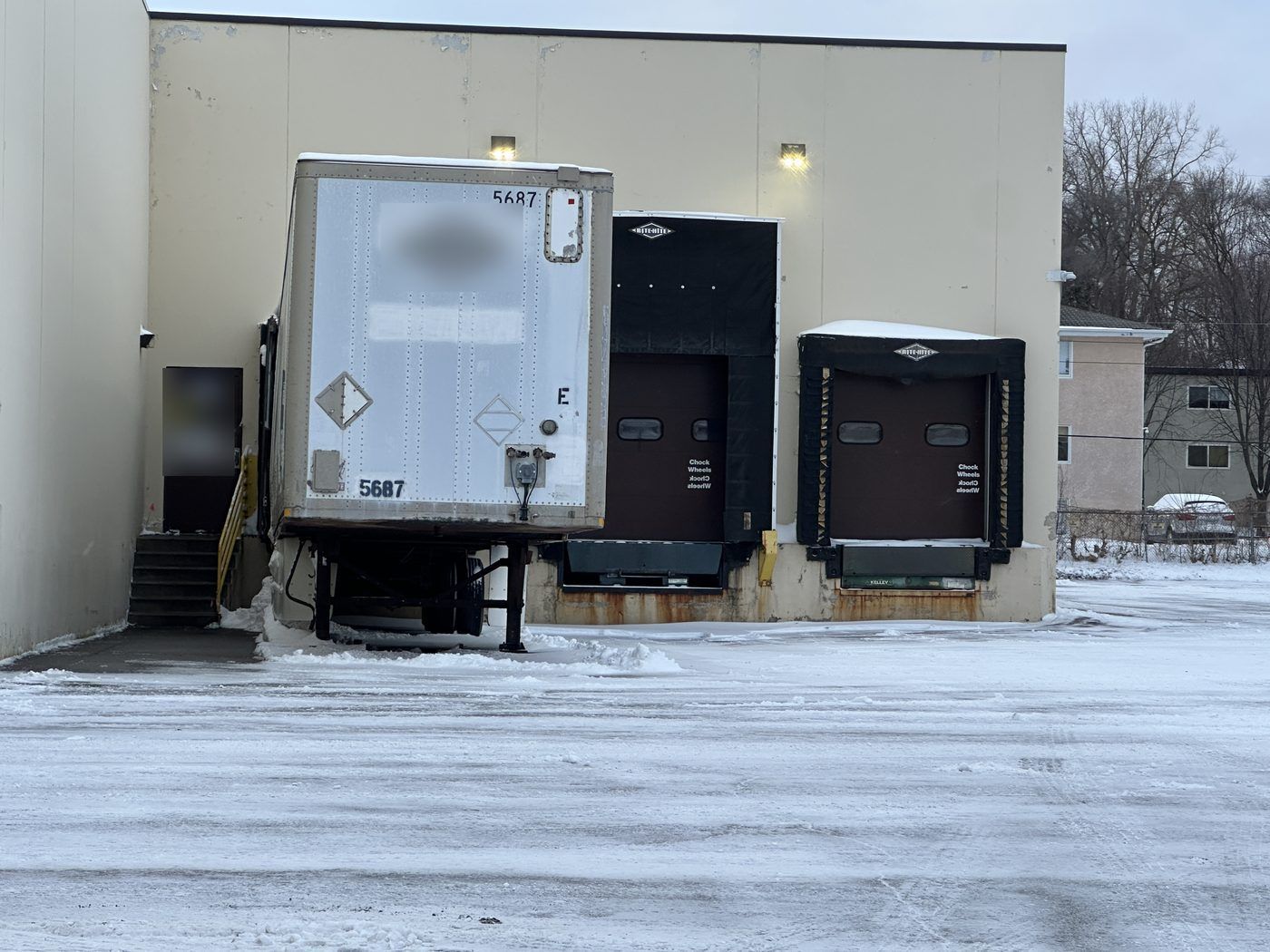 Loading dock doors at a small warehouse after a snow event