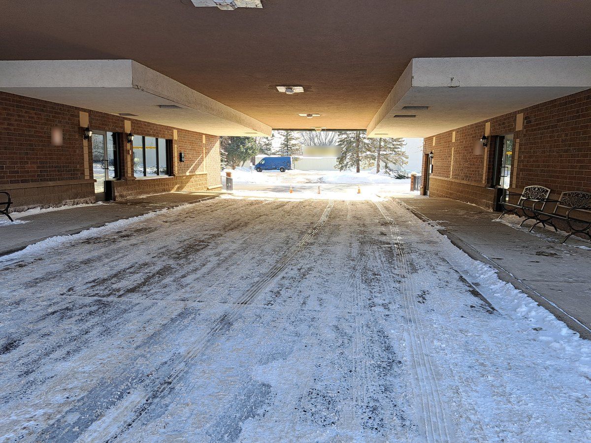 Covered drive-up entrance with the drive plowed and the walks on both sides cleared