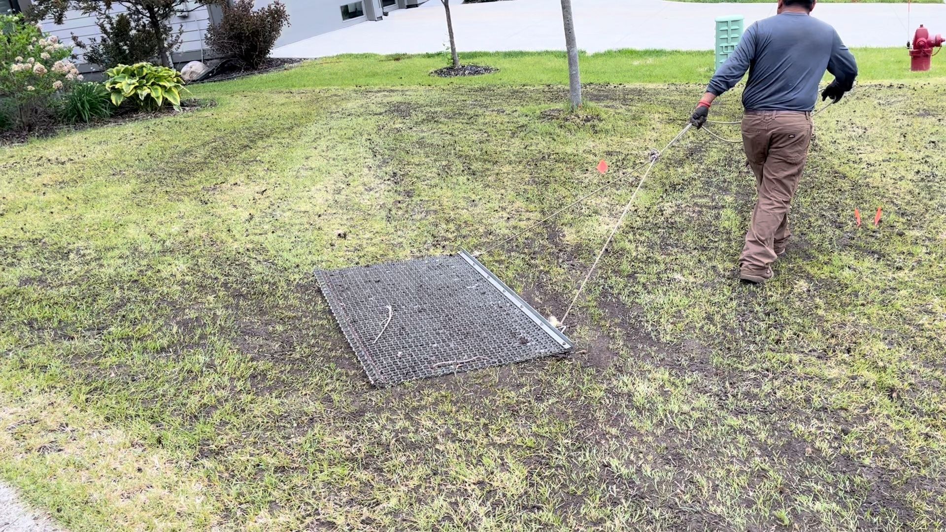 Drag mat leveling organic topdressing in Minnesota. 