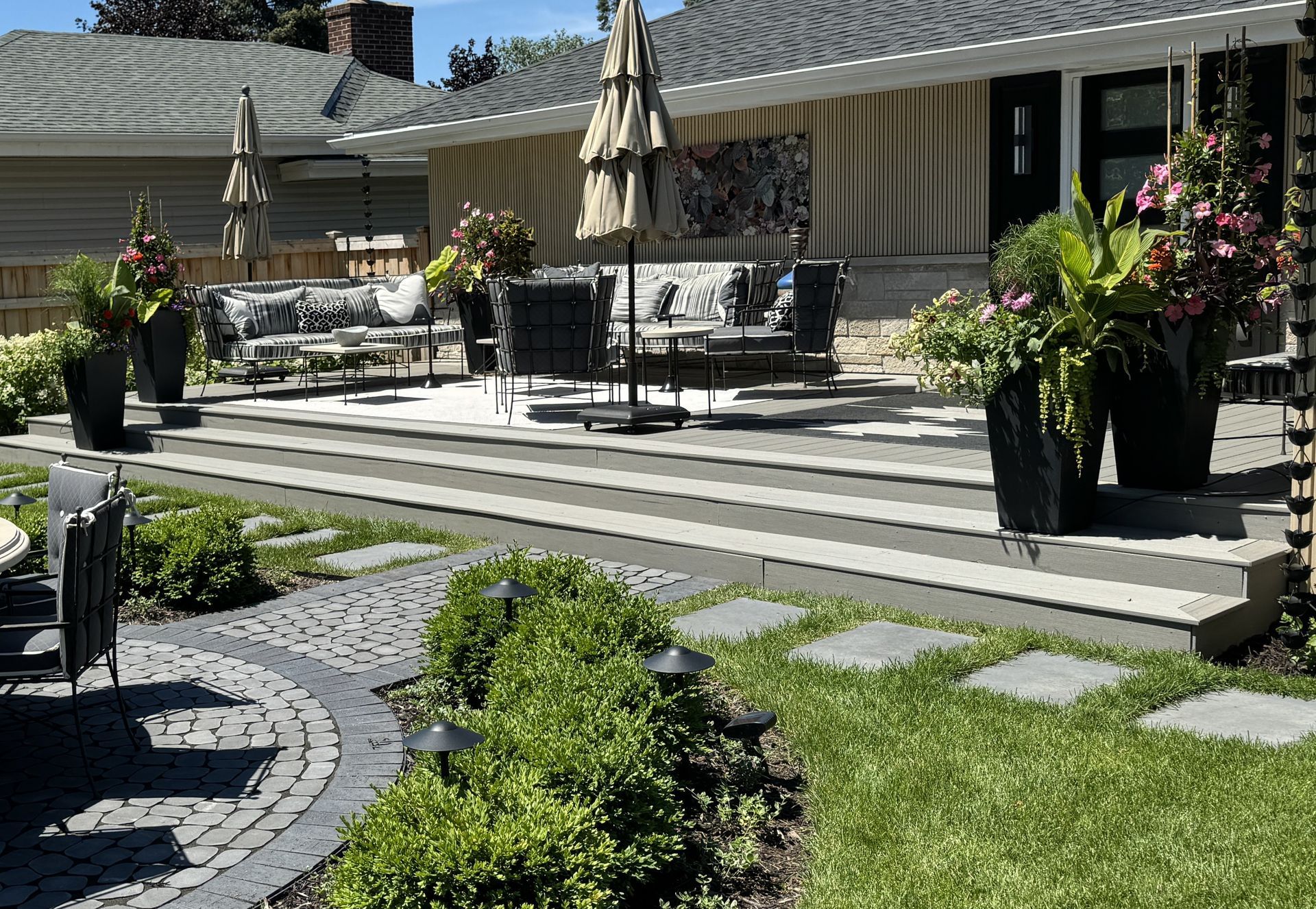 Maintenance-free deck with landing and steps down to a lawn-grade dining patio in Edina MN