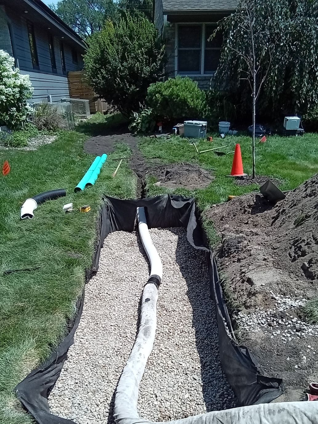 During: dry well pipe excavated lined with fabric and rock filled up to the drain pipe discharge elevation