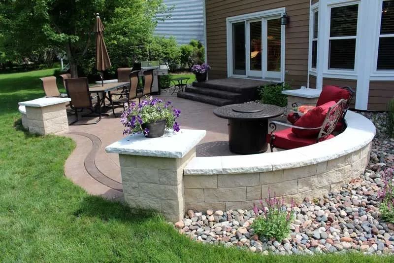 Designed backyard patio with sitting wall and stone column KG Landscape Eden Prairie MN 