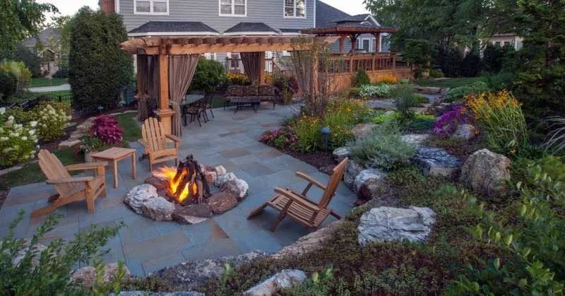 dream backyard landscaping bluestone patio with pergola fir pit colorful plants cedar structures 