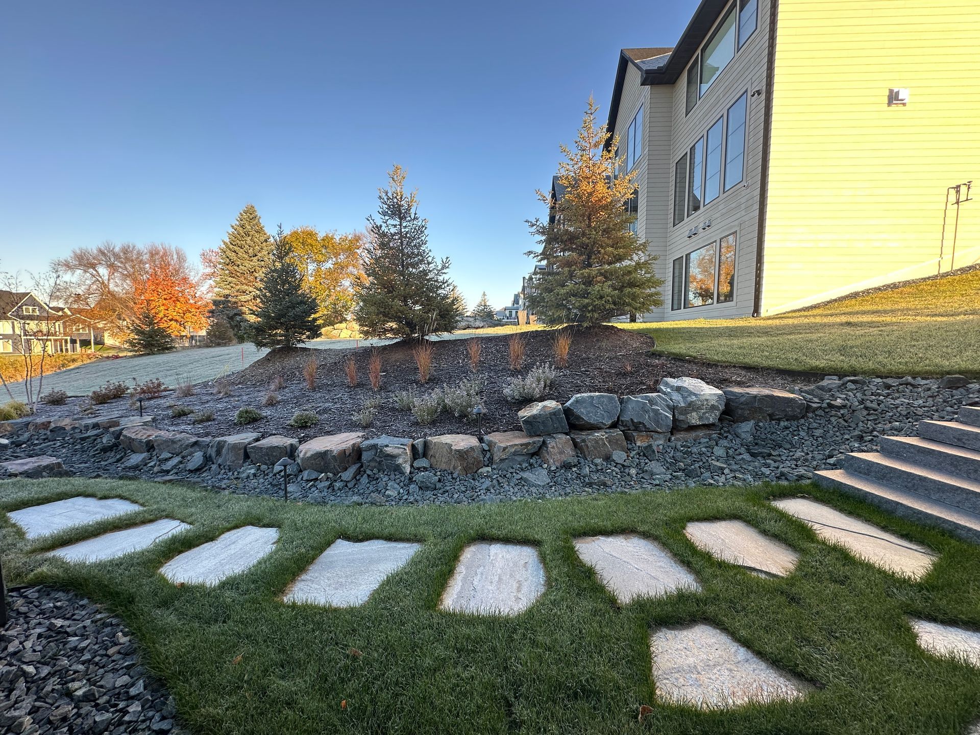 Side yard stone steps and large flagstone pathway set in the lawn project by KG Landscape 
