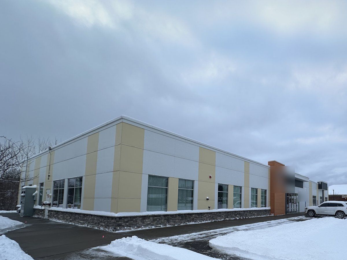 Flex office building and its plowed parking lot after a snowfall