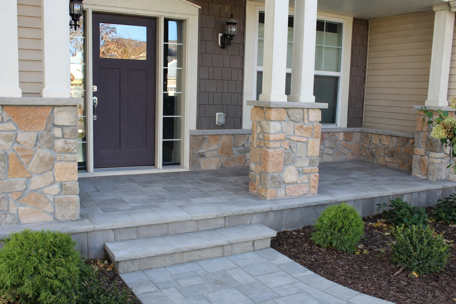 A project we did in Blaine - new paver front walkway with porch faced in matching stone project by KG Landscape