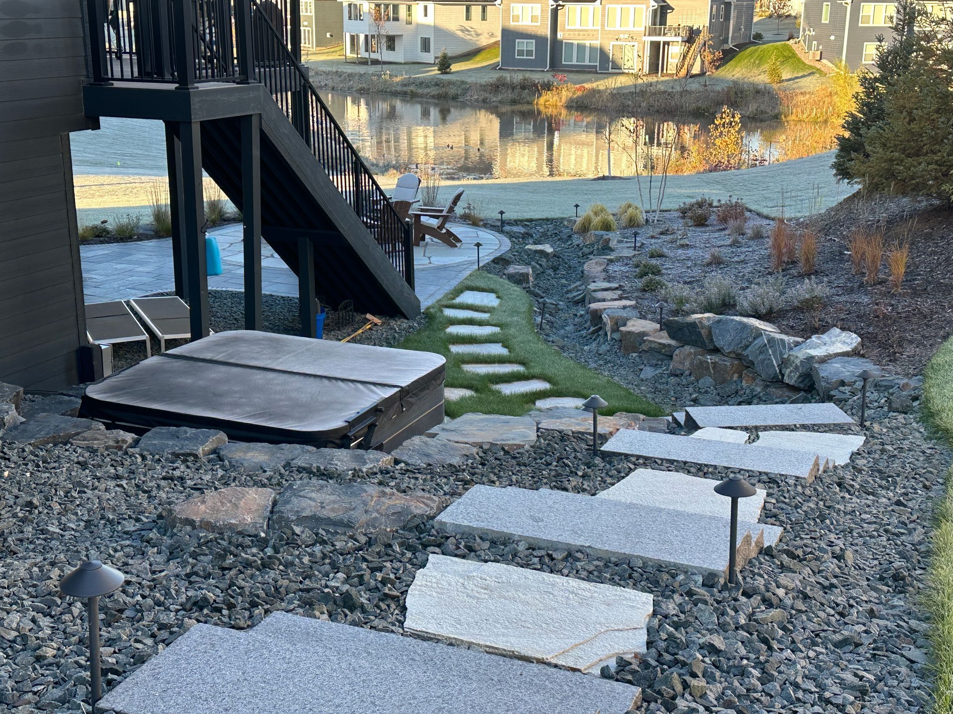 Granite hillside steps with trap rock around them in a side yard in Plymouth MN project by KG Landscape 