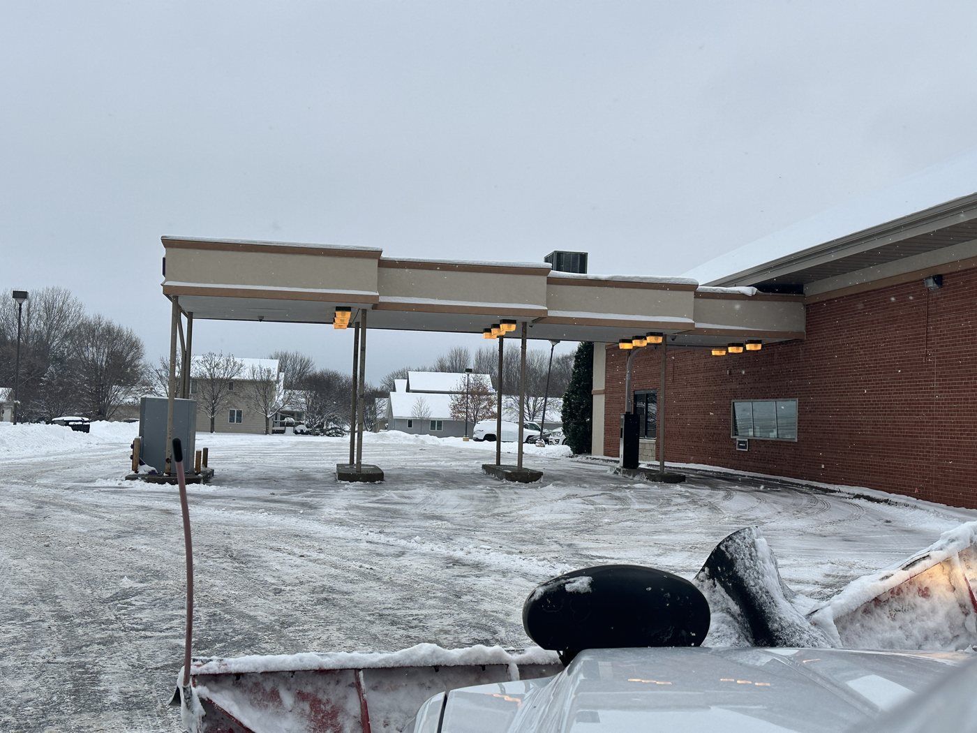 Drive-through lanes under a building canopy after snow plowing