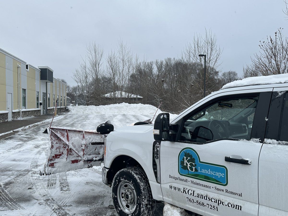 KG Landscape truck with a snow plow parked at an office lot