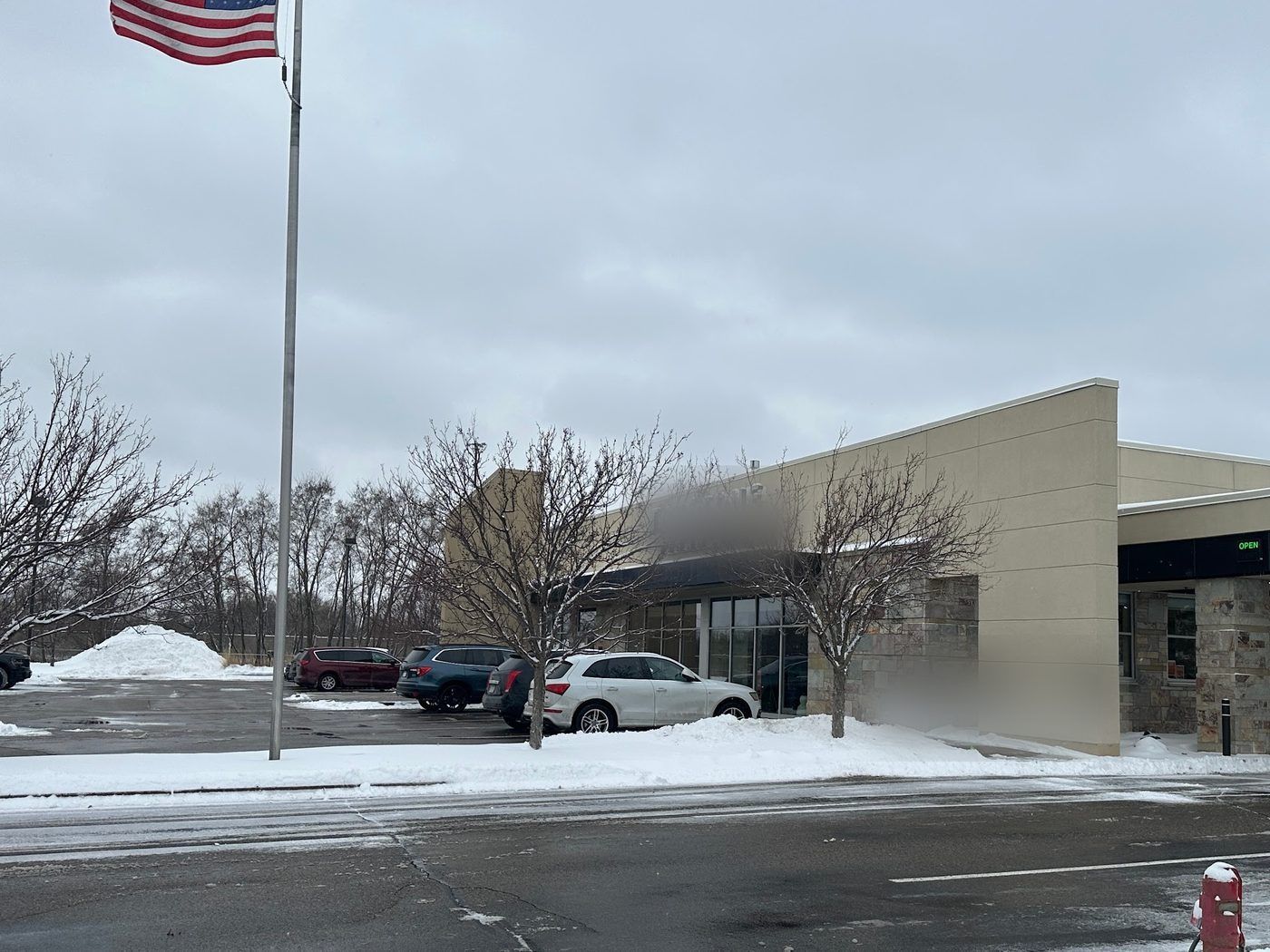 Plowed street and lot in front of a commercial building