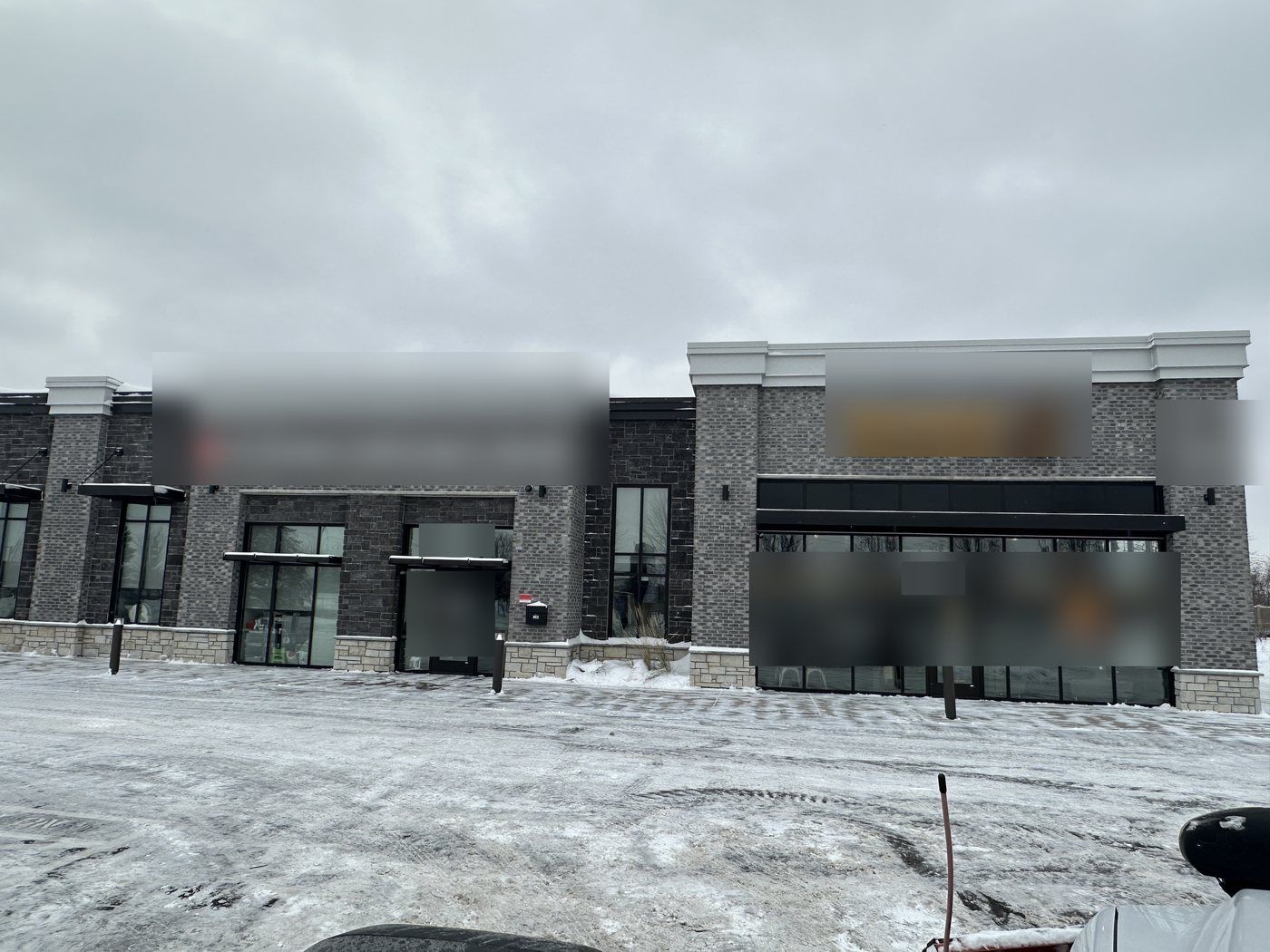 Newer storefront row facing a freshly plowed parking area