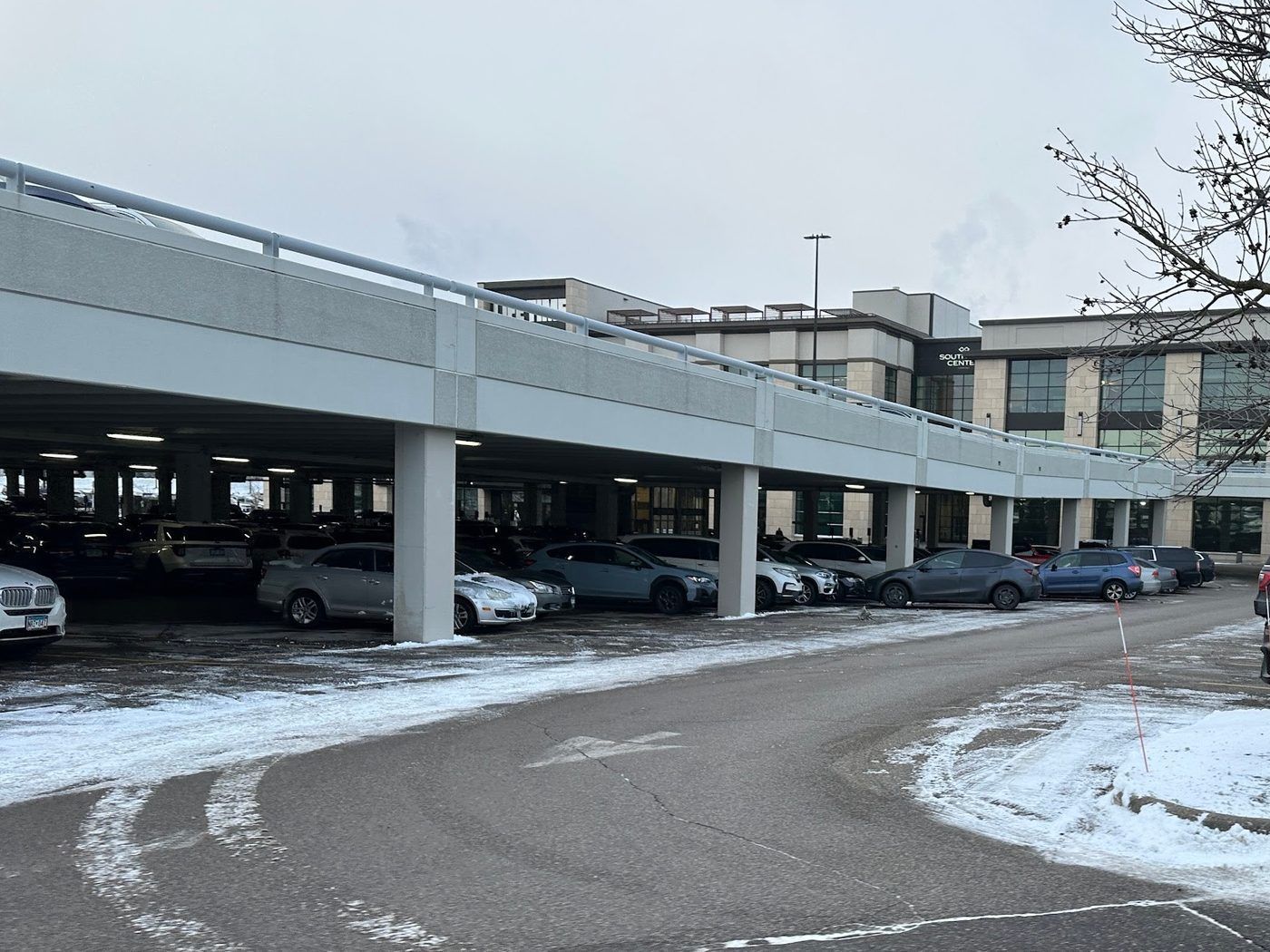 Curved drive in front of a covered parking ramp at an office campus