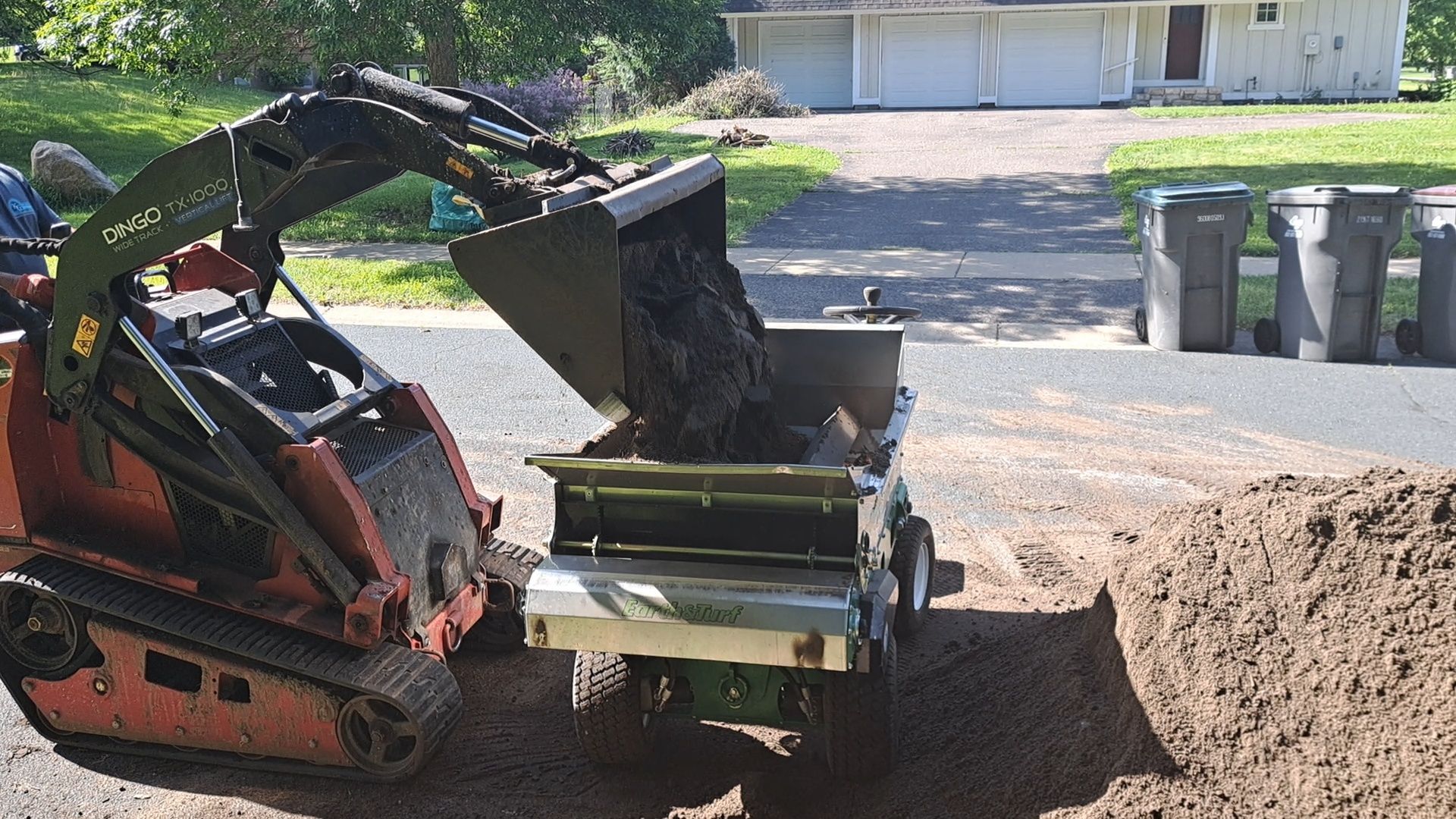 Loader filling organic topdressing. 