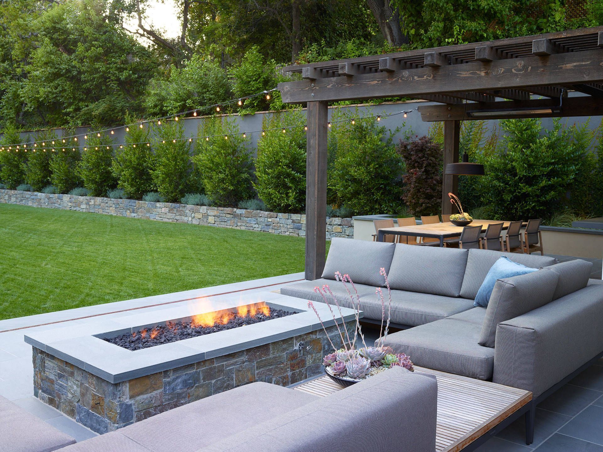 A patio with a fire pit and a couch