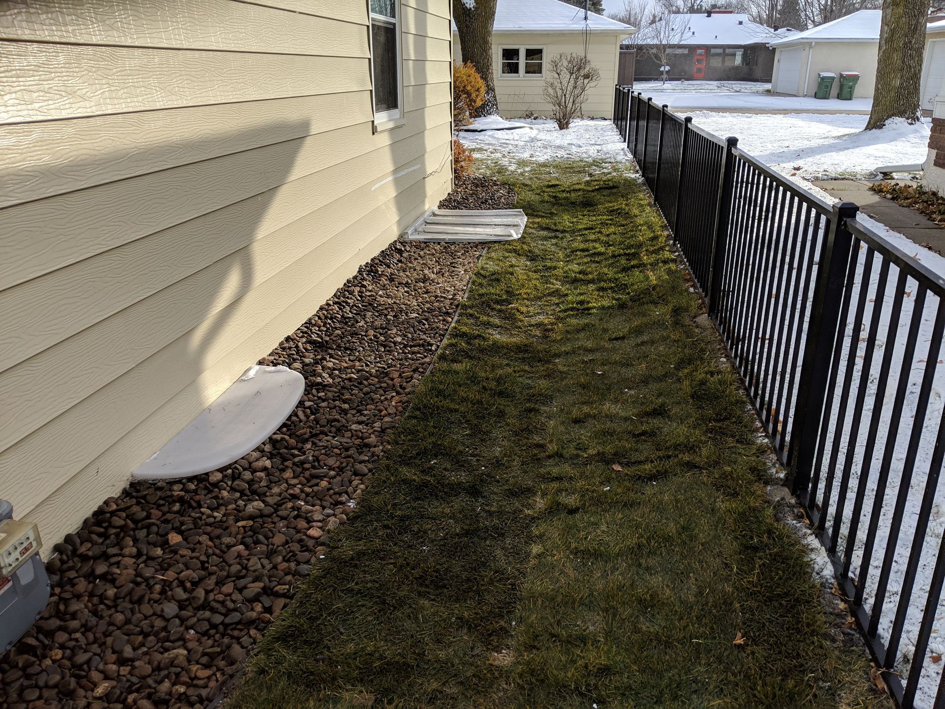 New foundation landscaping with, proper slope, poly liner, rock and new edging