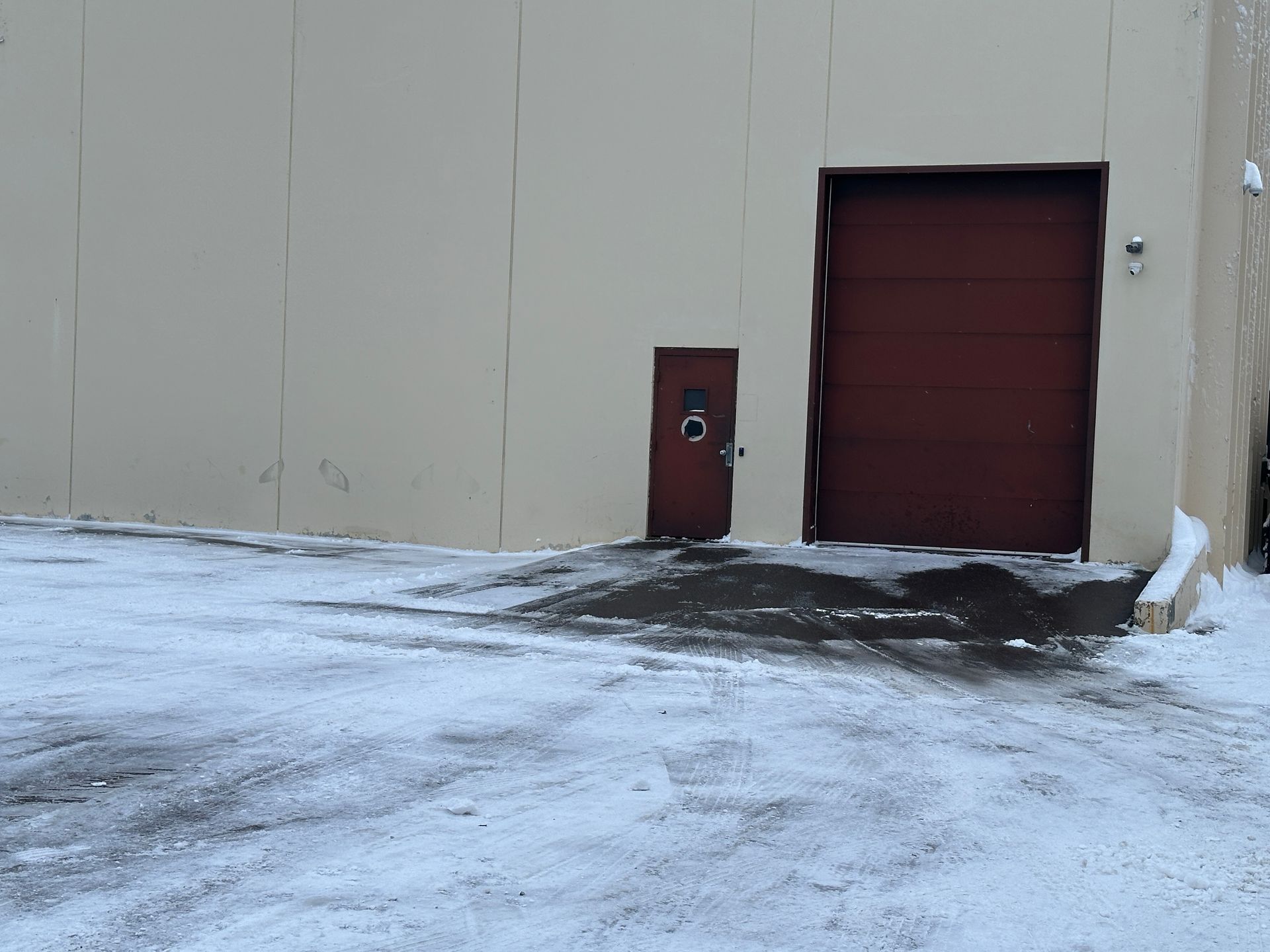 Neatly shoveled, plowed, and salted garage entrance at a commercial building in Minnesota