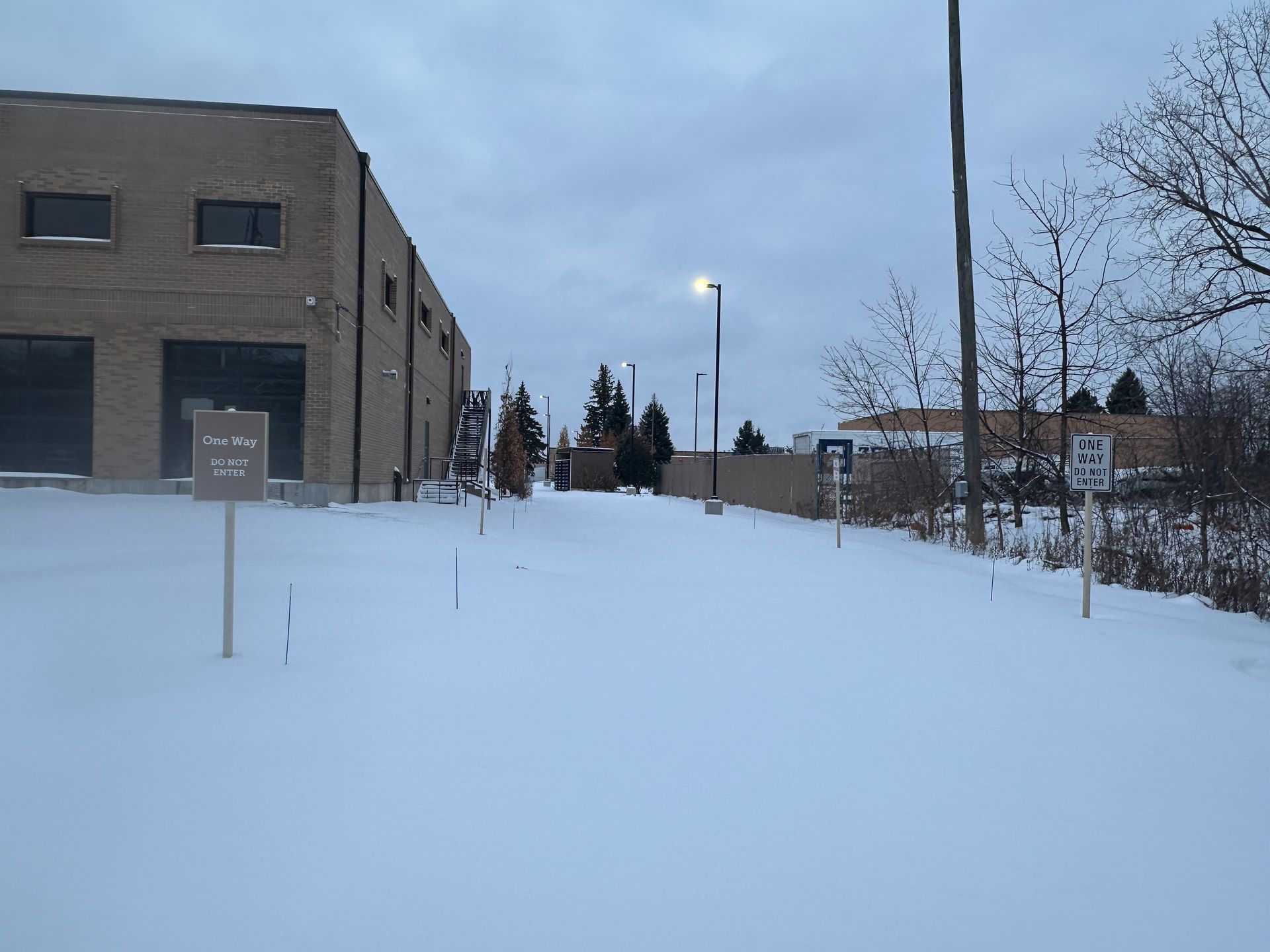 Parking lot drive lane marked with snow stakes in Minnesota