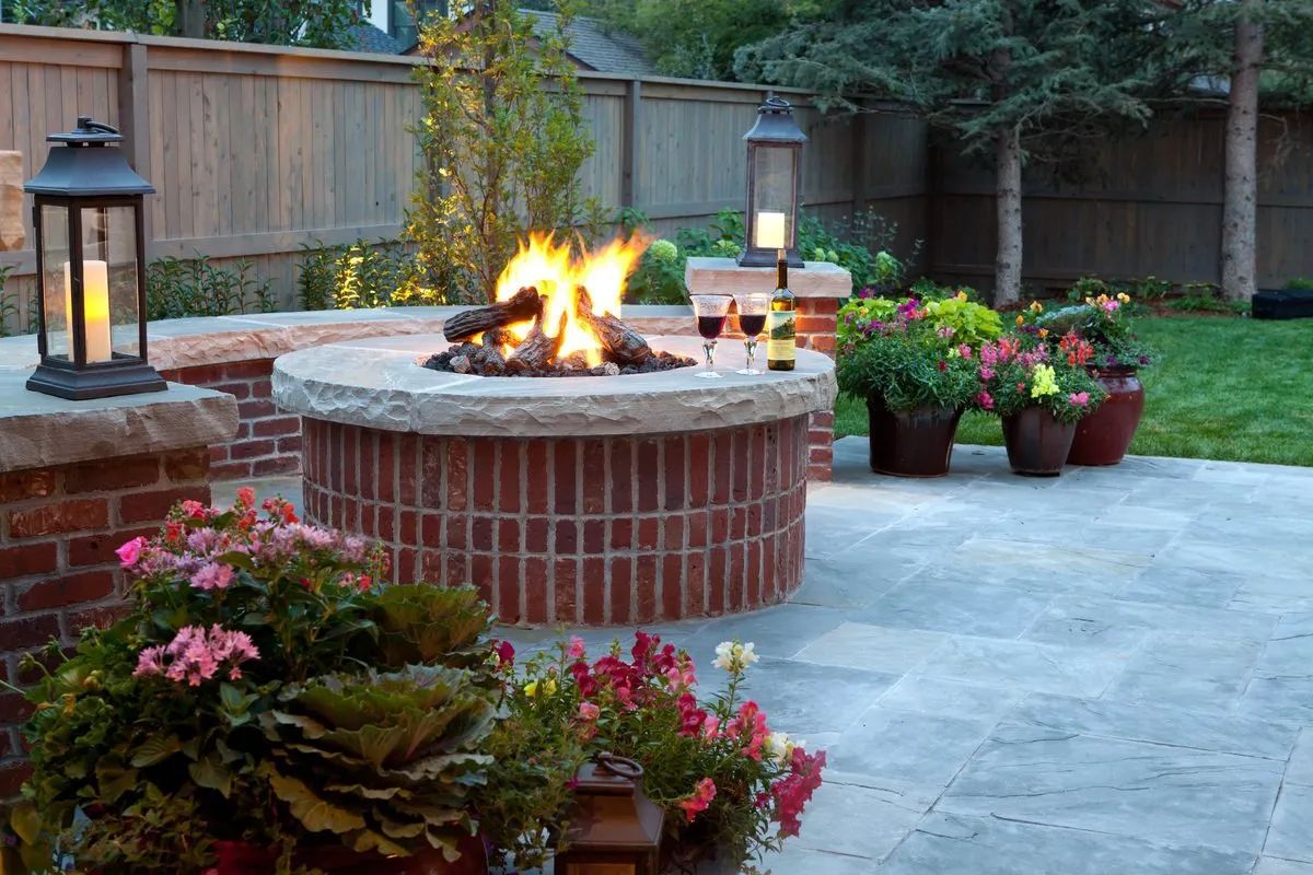 Brick fire pit on patio with flame beautiful backyard MN 