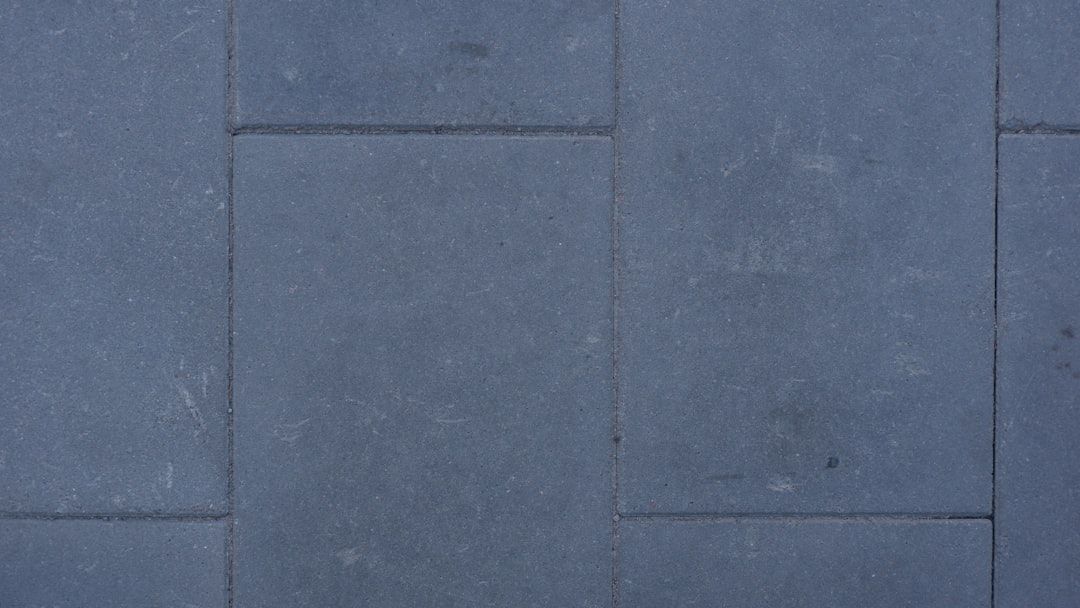 A close up of a row of gray bricks on a sidewalk.