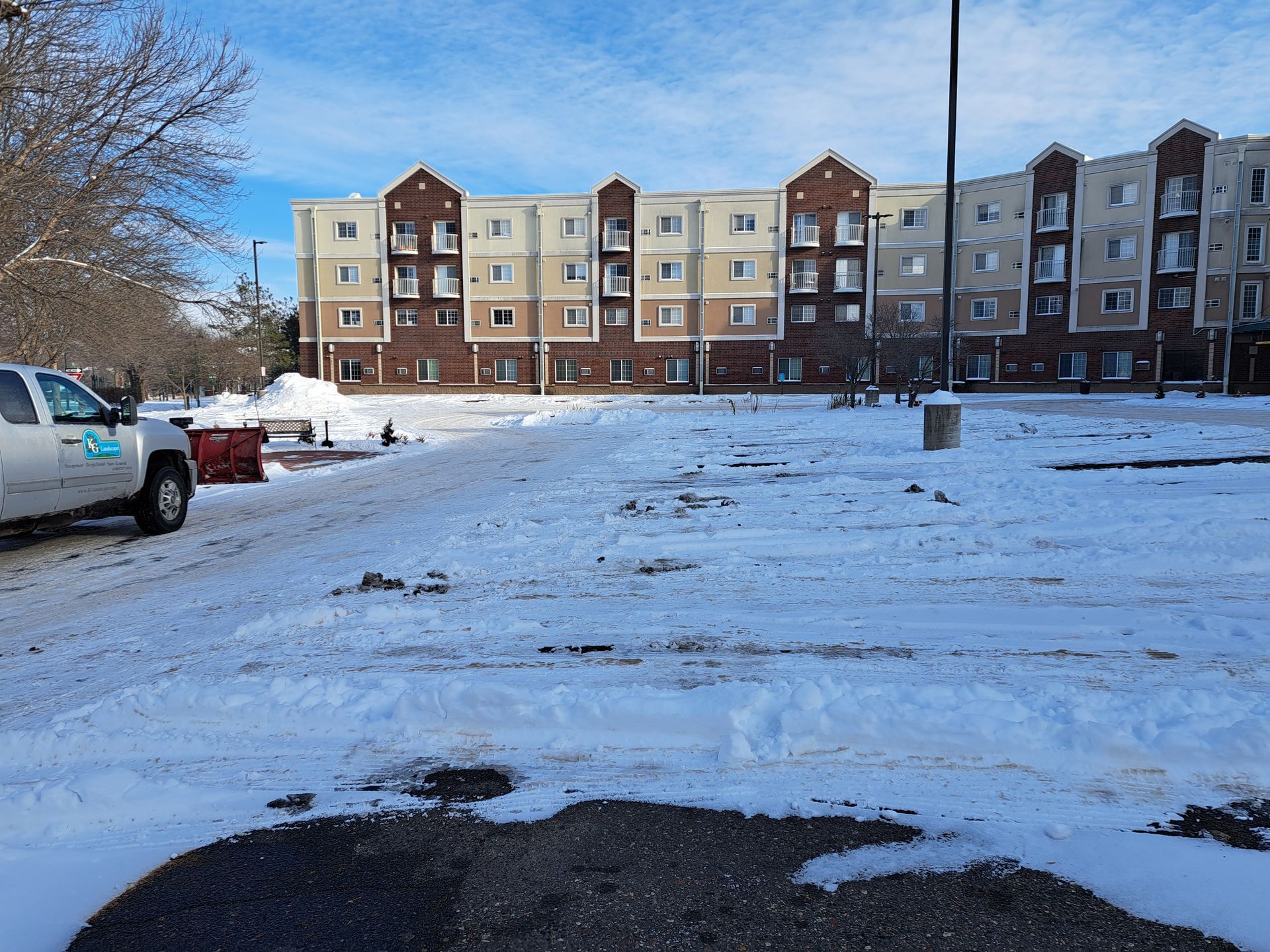Plow truck clearing parking spaces after cars moved the next day in Minnesota