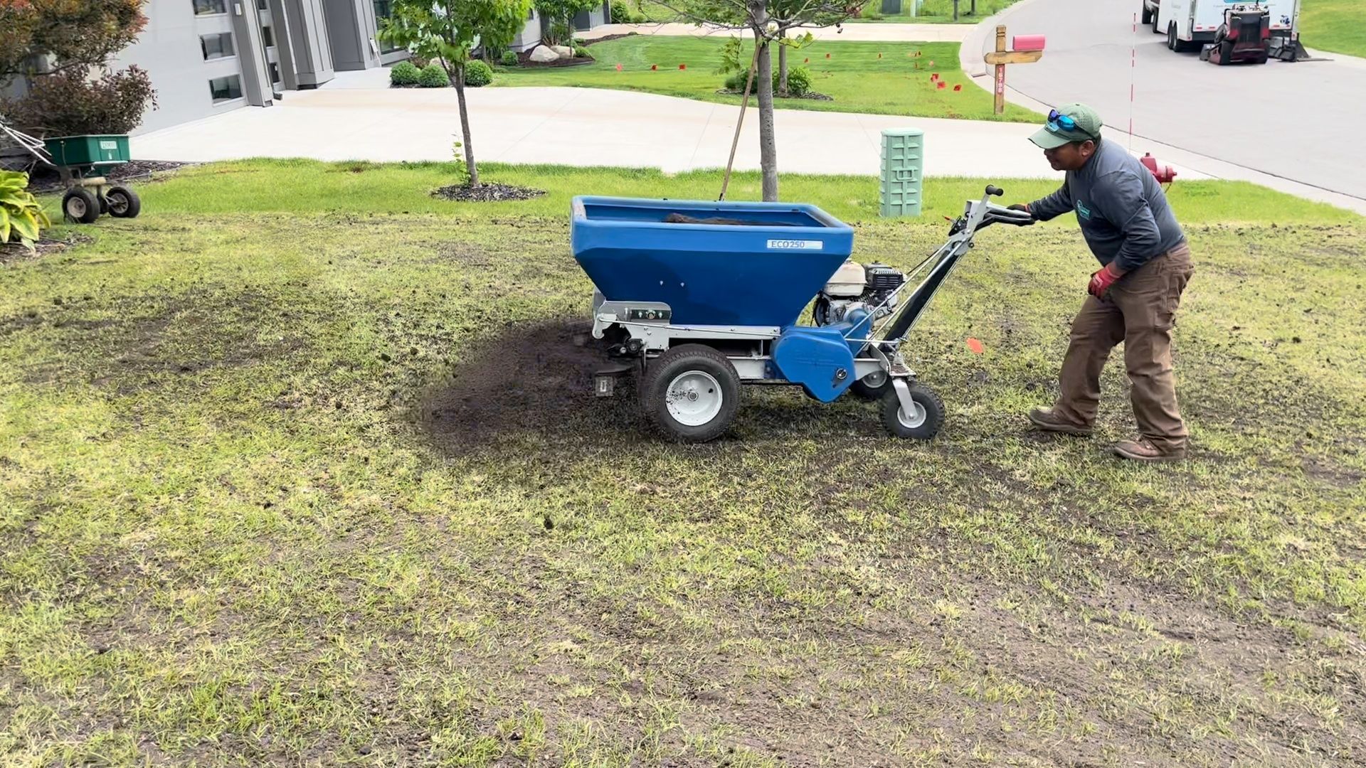 Push spreader applying organic top dressing