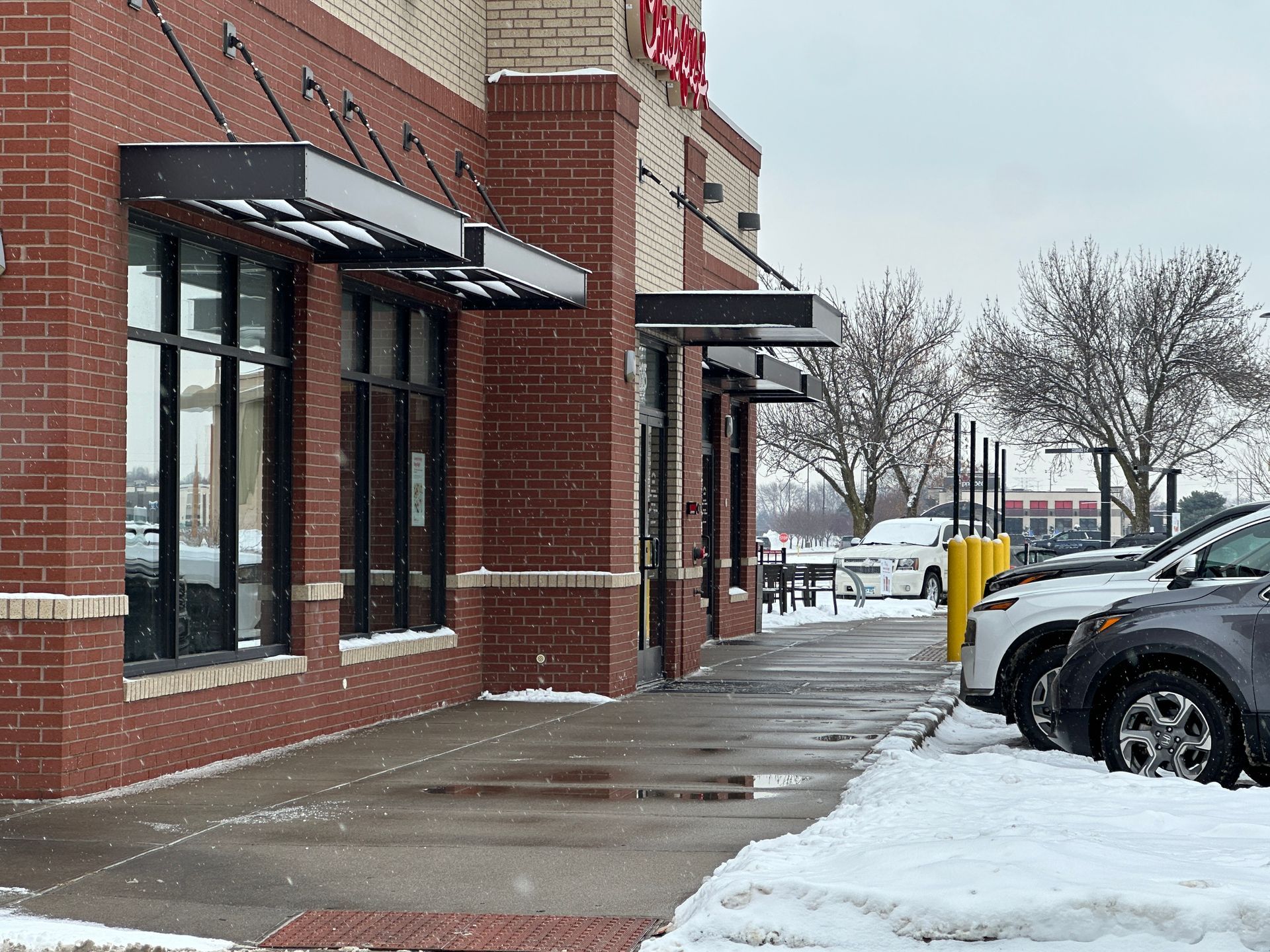 Restaurant sidewalks shoveled and salted during a snow event in Minnesota