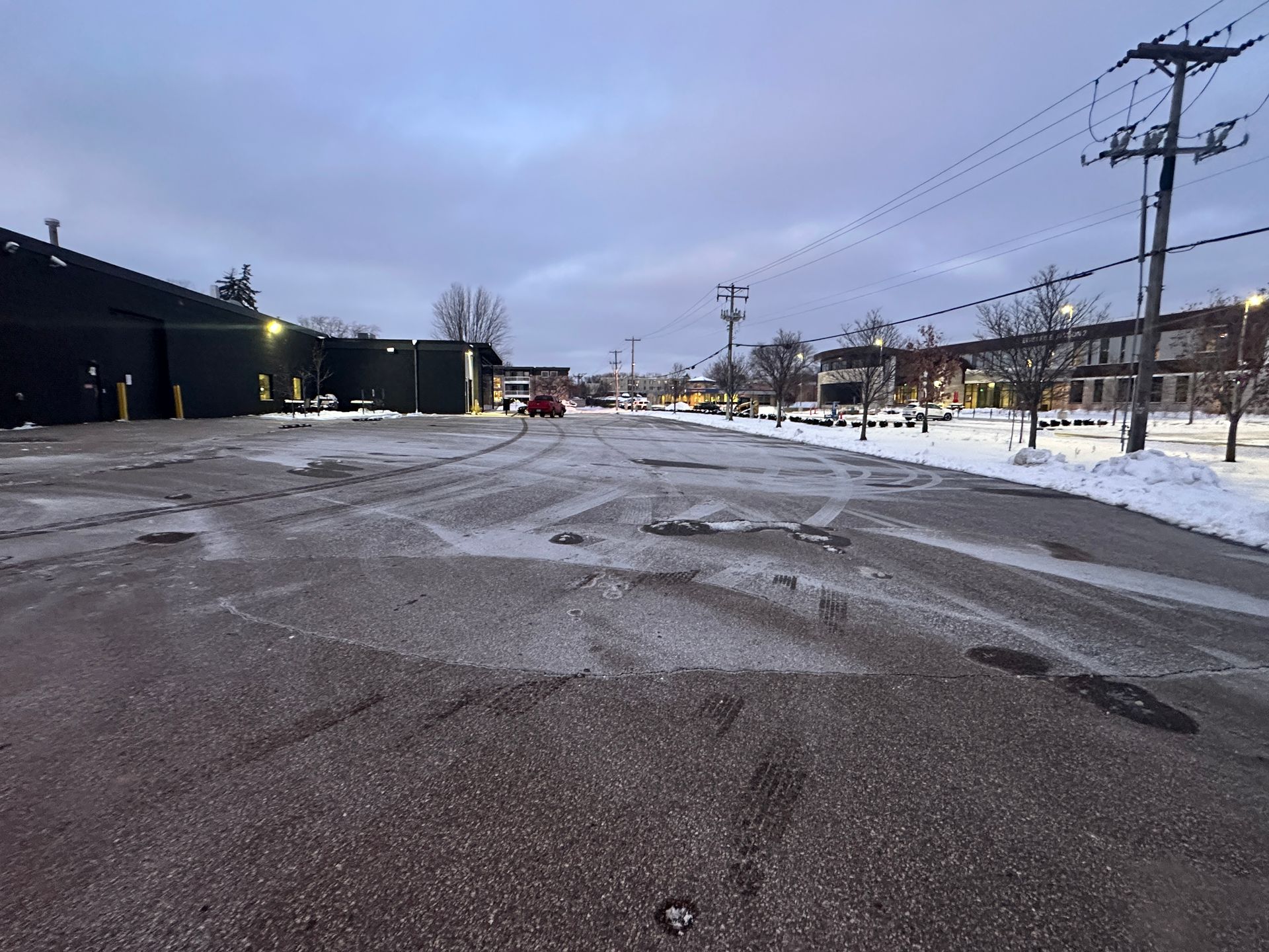 Salted small business parking lot cleared to pavement in winter in Edina, MN