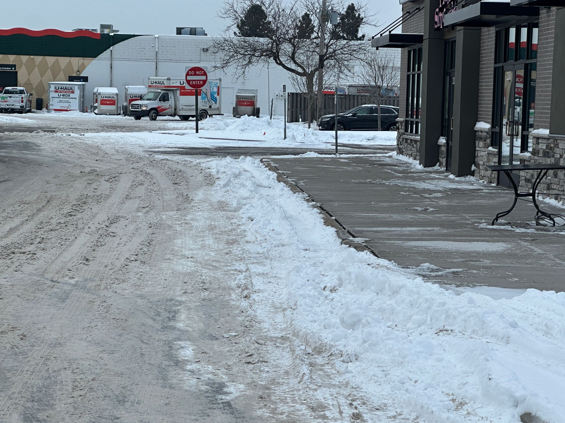 Snow piled along curbline from sidewalk clearing creating an unsafe condition in Minnesota
