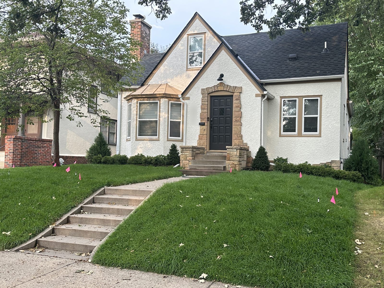 New sod covering a front yard slope beside concrete steps in Minneapolis
