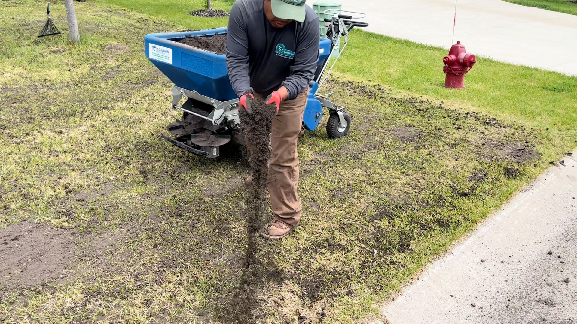 Spreading organic topdressing and fertilizer on lawn. 