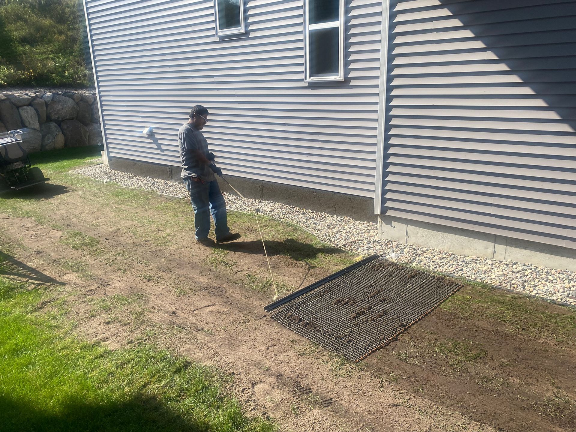 crew leveling soil after lawn renovation in St. Paul suburb 