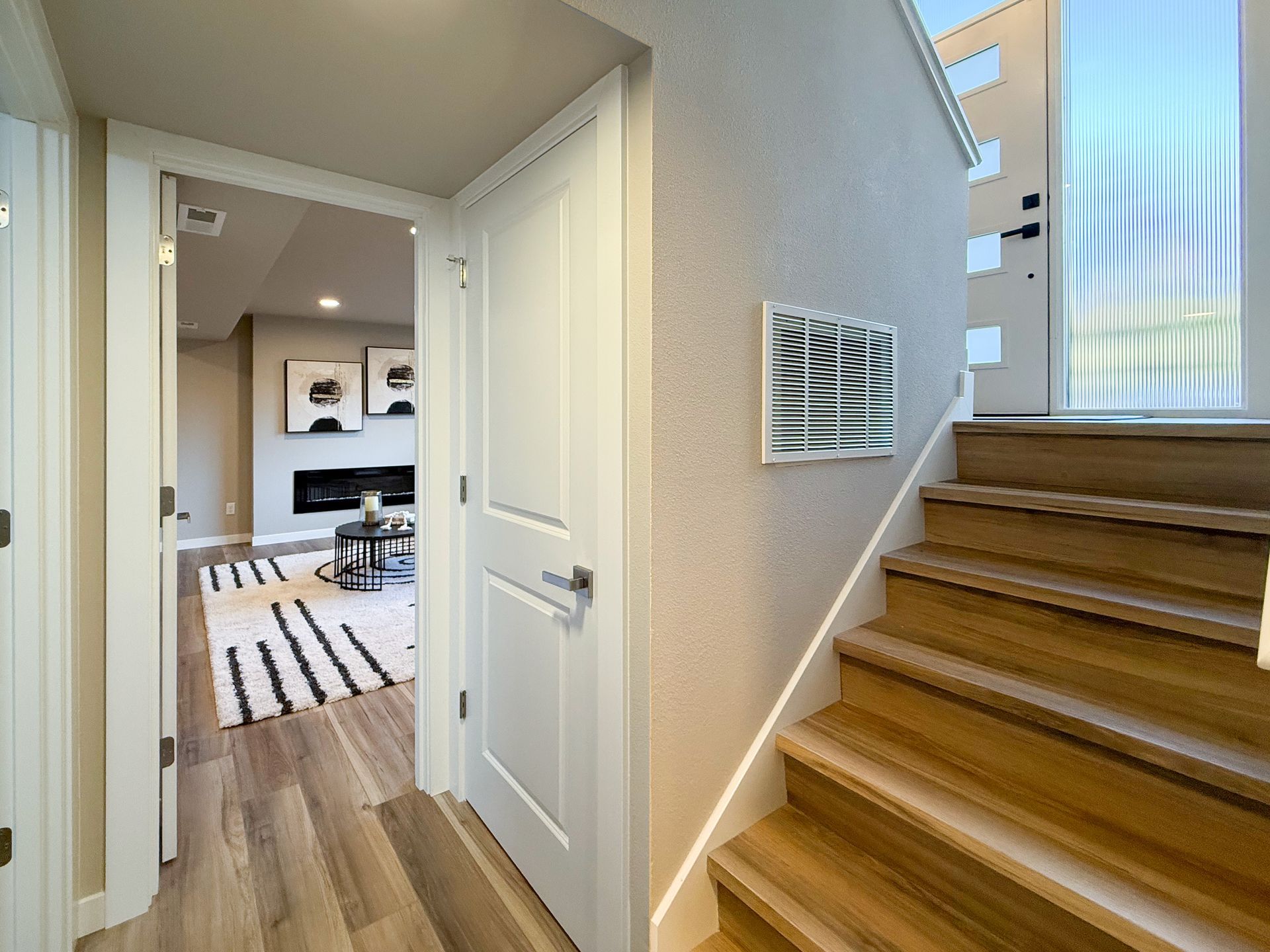 Staircase and bonus room with rug