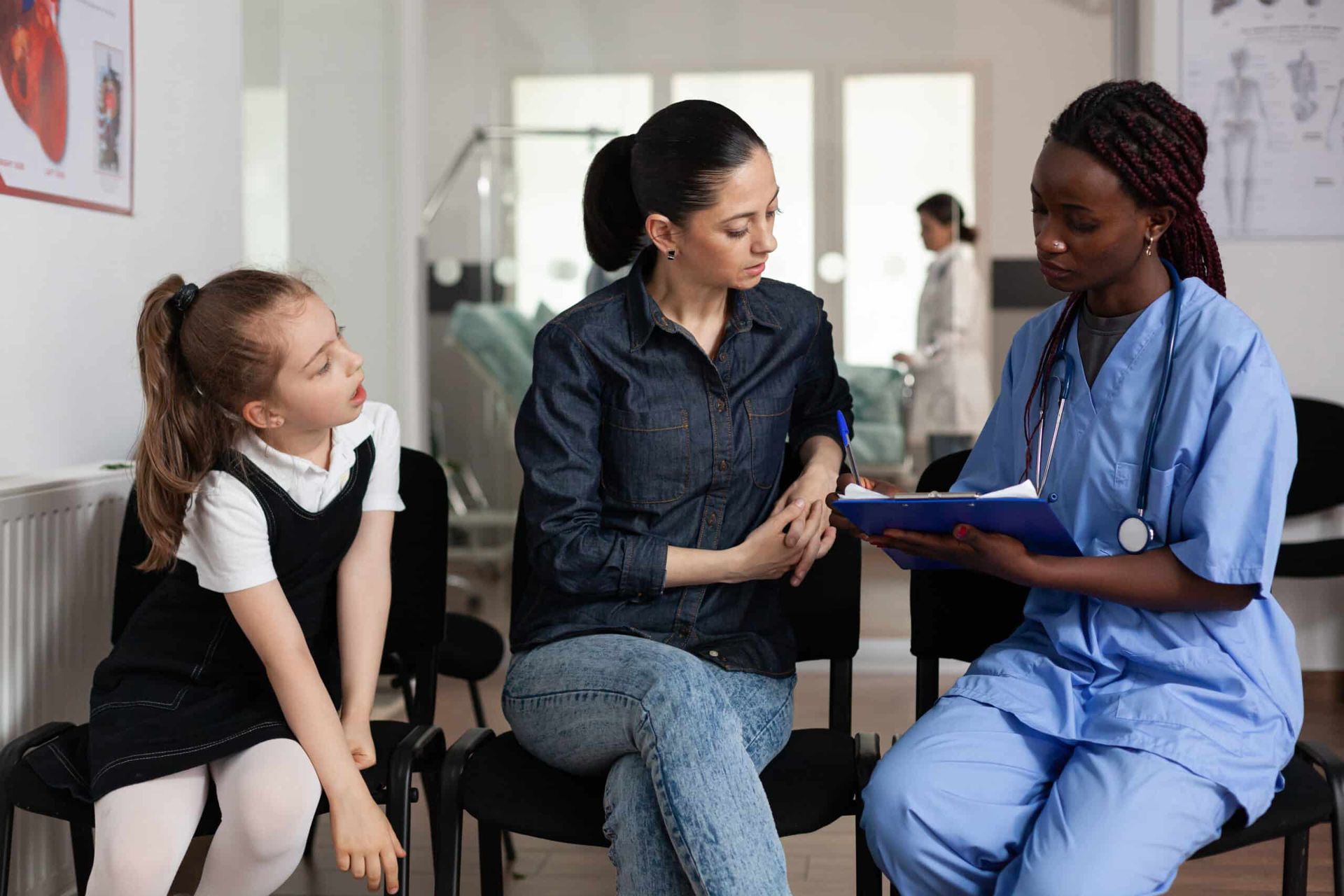 Doctor consulting with a parent and child in a clinic waiting room