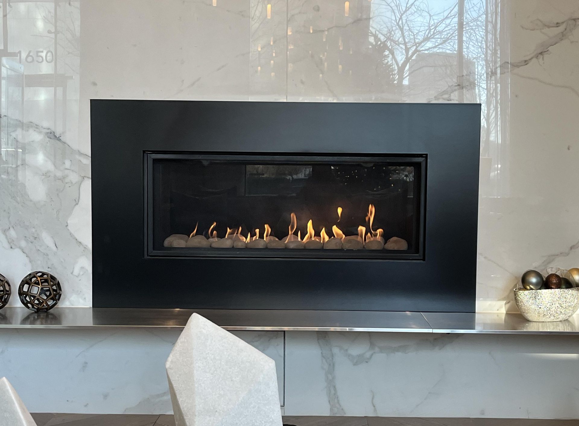 Black Fireplace With Flames Set In Marble Surround — Falls Church, VA — Nova Gas Black Fireplace With Flames Set In Marble Surround — Falls Church, VA — Nova Gas
