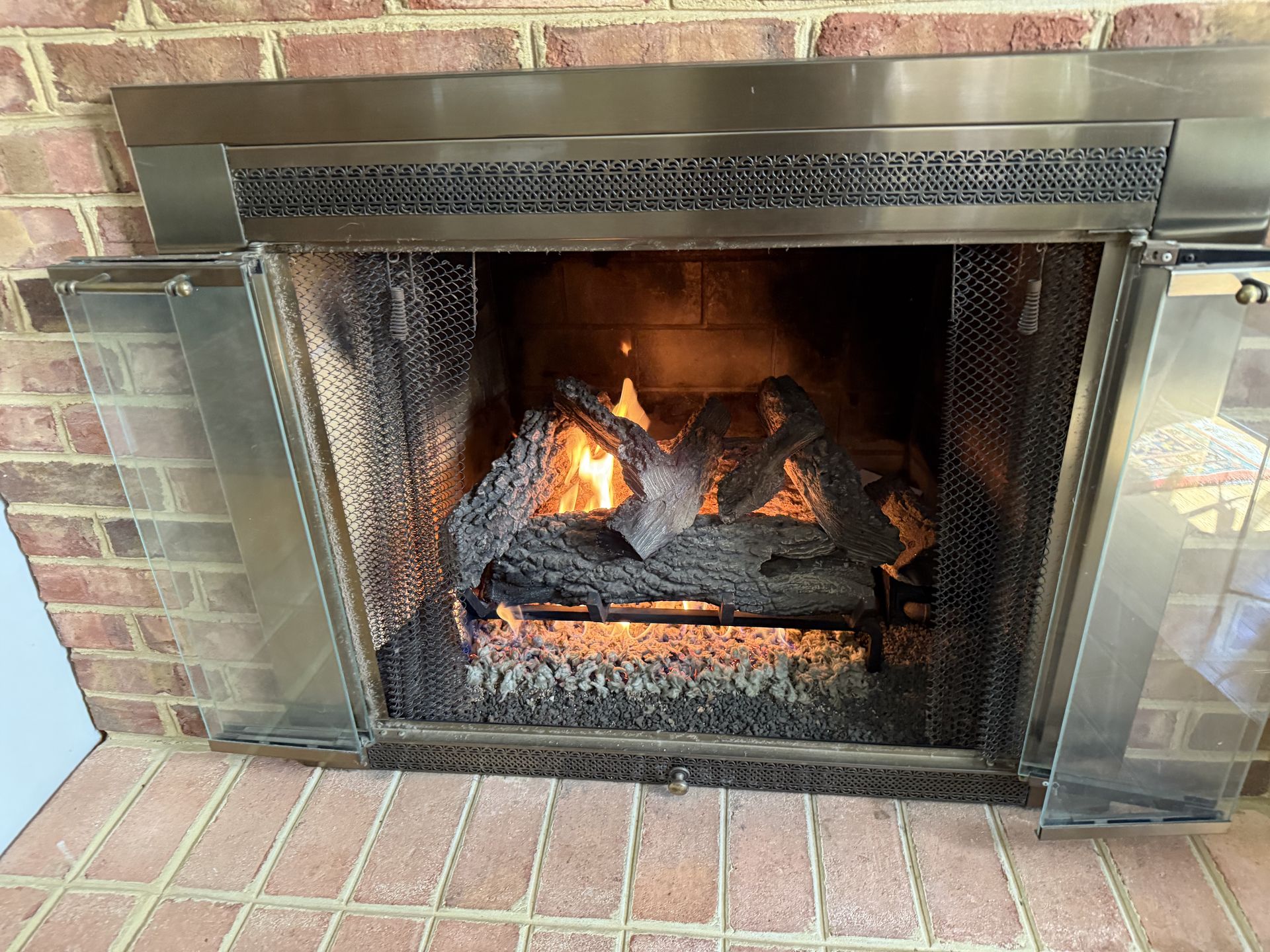 Fireplace With Burning Gas Logs, Surrounded By Brick And Metal Framing. — Falls Church, VA — Nova Gas Fireplace With Burning Gas Logs, Surrounded By Brick And Metal Framing. — Falls Church, VA — Nova Gas