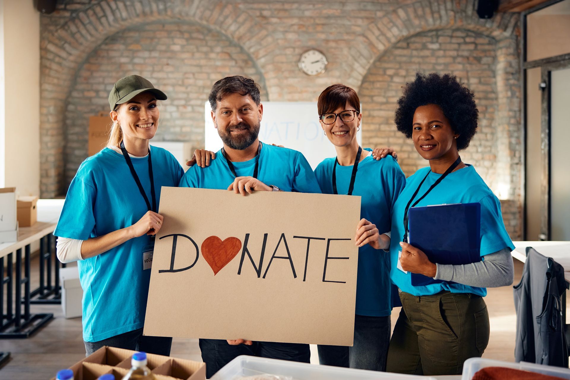 A group of people are holding a sign that says `` donate ''.