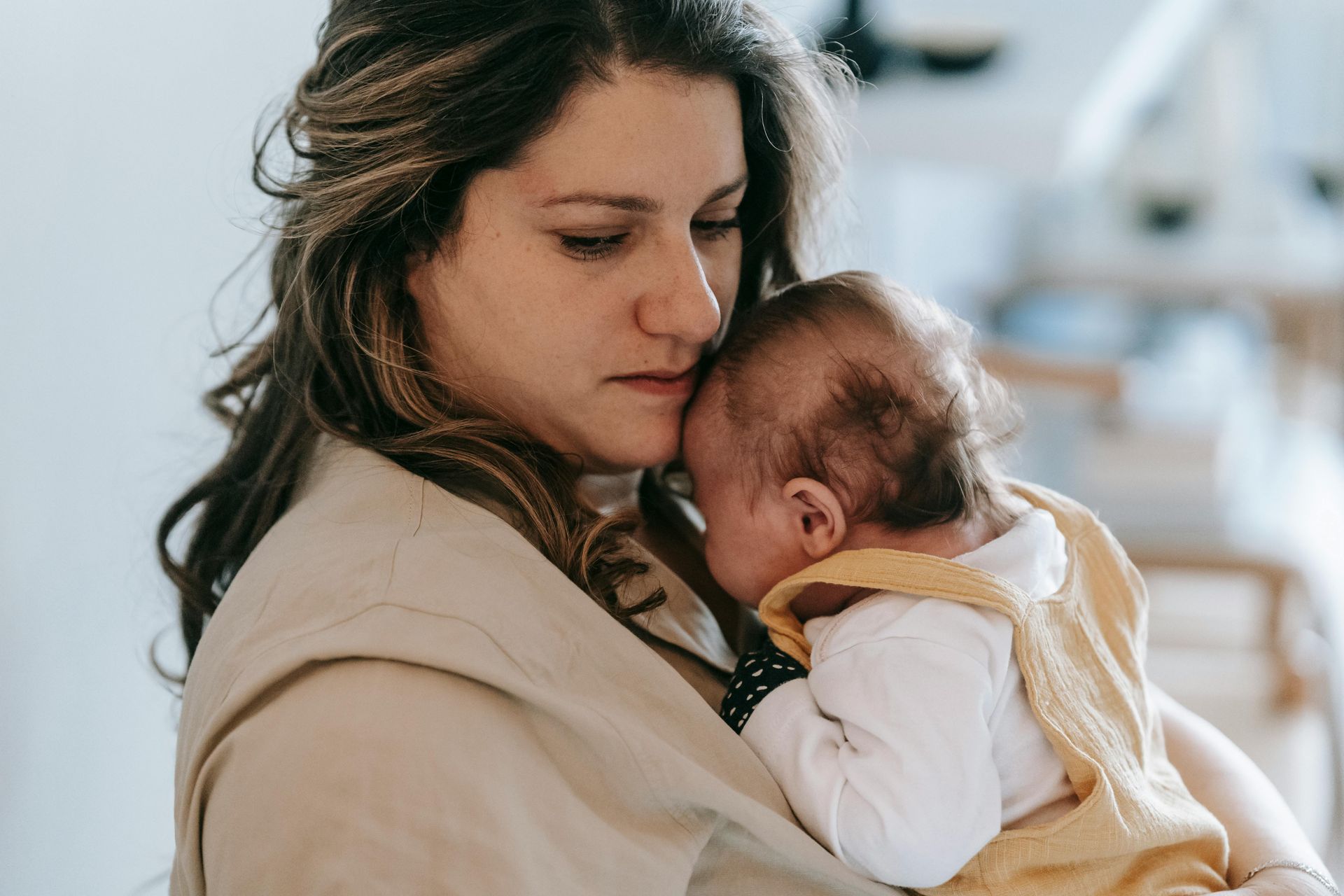 a mother embracing her baby, showing the importance of empowering mothers in need
