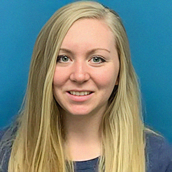 Blonde woman smiling, with a blue background.
