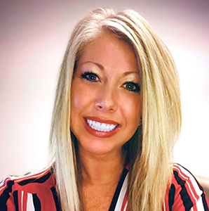 Blonde woman smiling, wearing a red striped shirt.